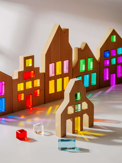 Colorful Canal House Blocks set showcasing translucent acrylic details and wooden houses in various shapes.