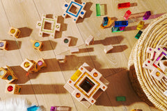 Frankie blocks wooden sensory blocks with sparkly gems and colorful light reflections, open-ended stacking and building play on floor