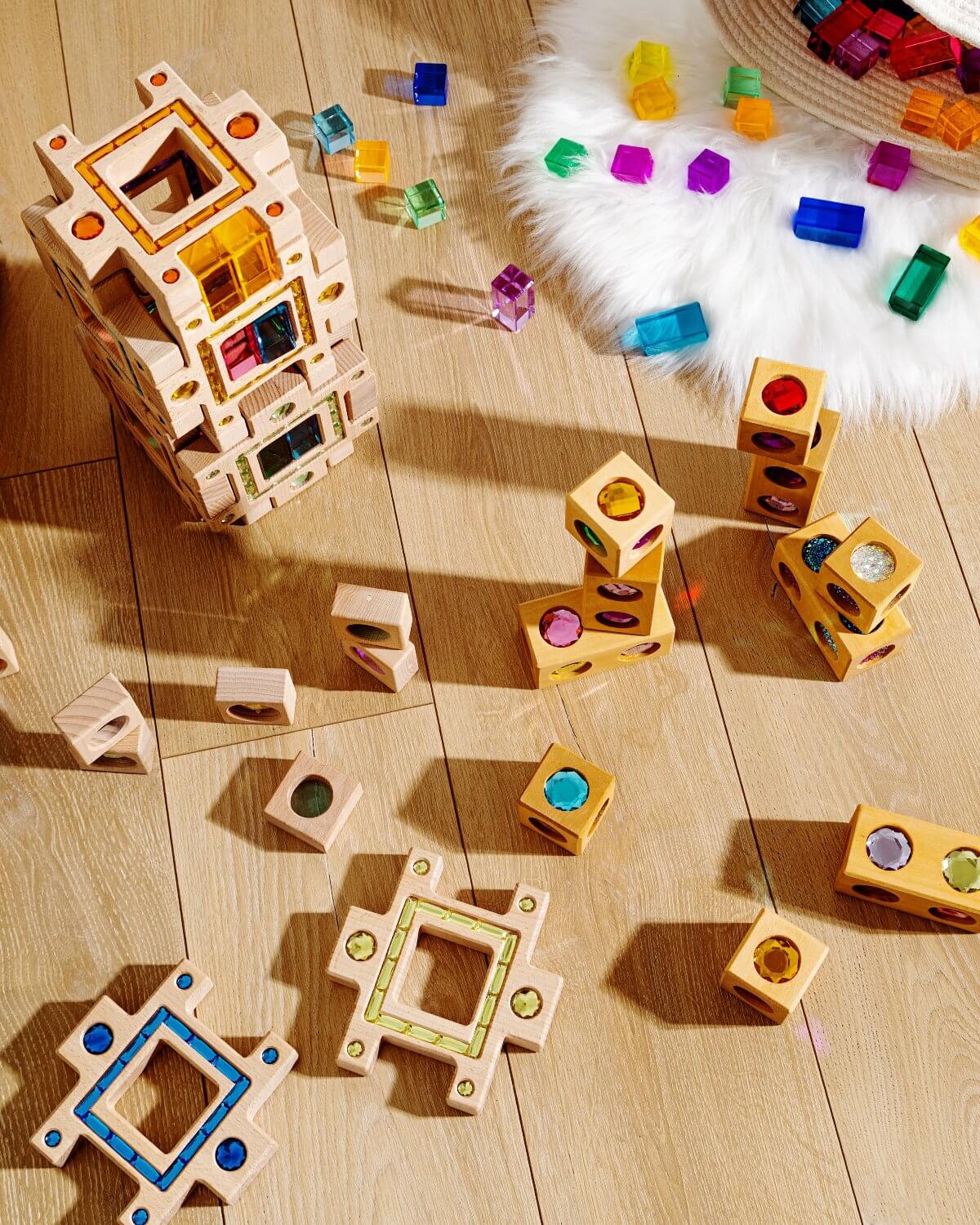 Frankie blocks wooden sensory building blocks with colorful gem windows, stacked shapes and light-reflecting cubes on wooden floor