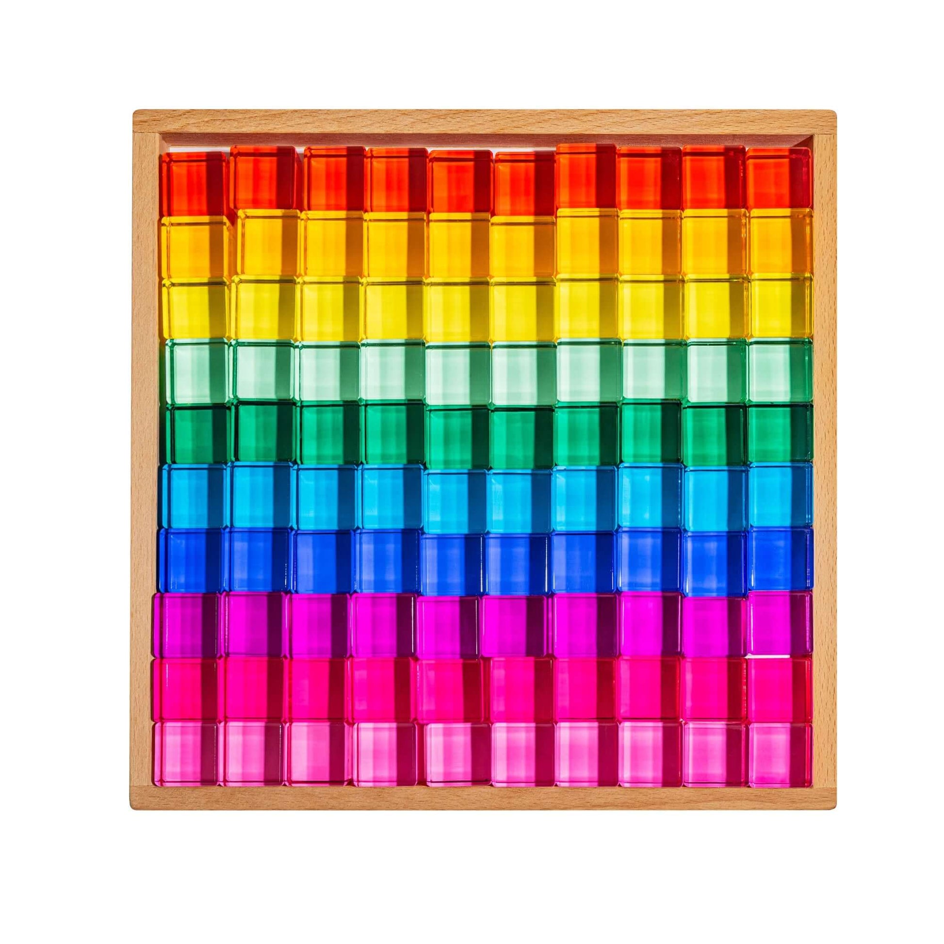 Colorful transparent blocks in a wooden frame on a white background