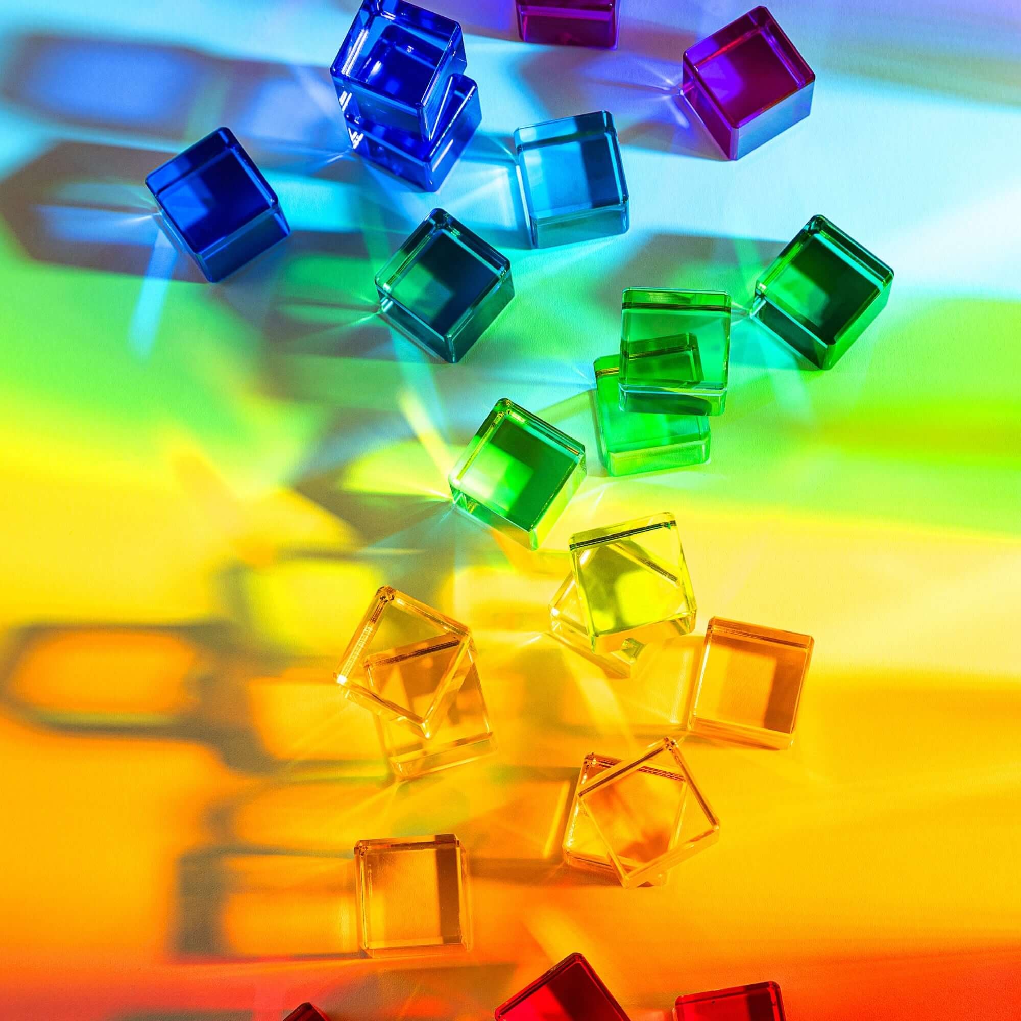 Colorful transparent cubes on a rainbow gradient background