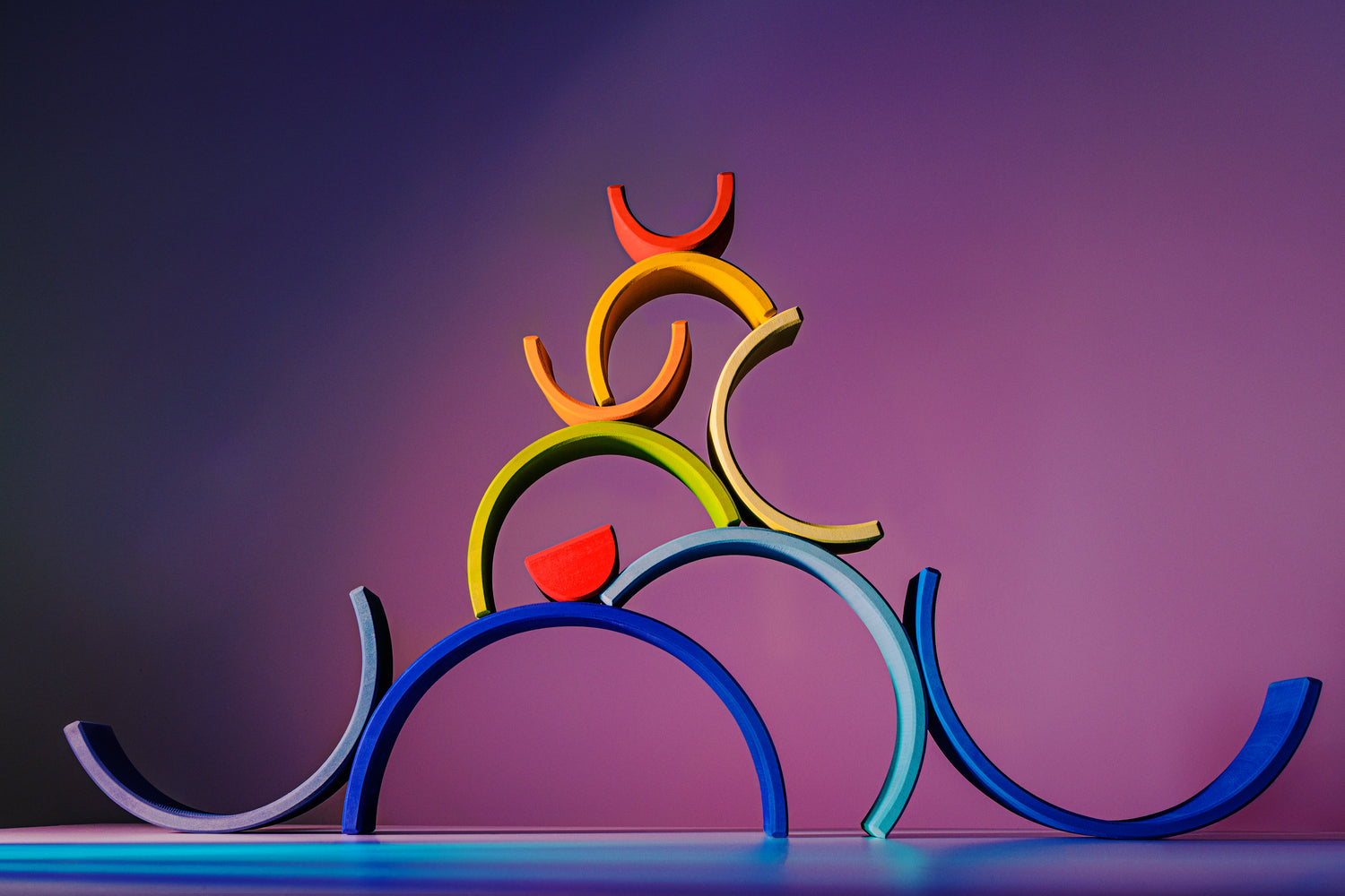 Colorful arrangement of the Large Wooden Rainbow stacking toy, emphasizing playful design and craftsmanship.