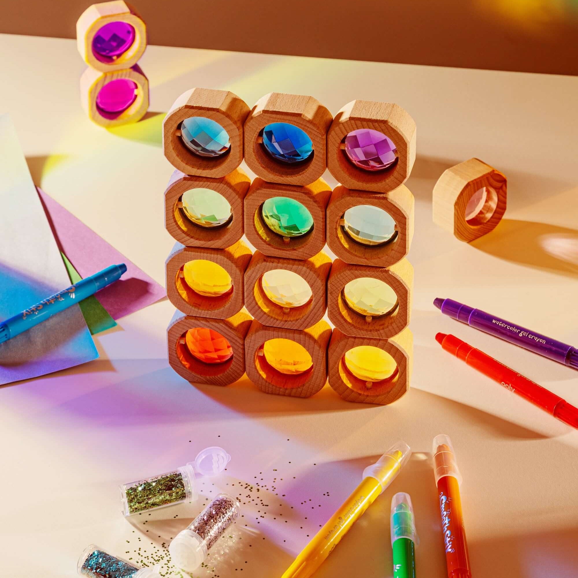 Colorful wooden block puzzle with markers on a light surface