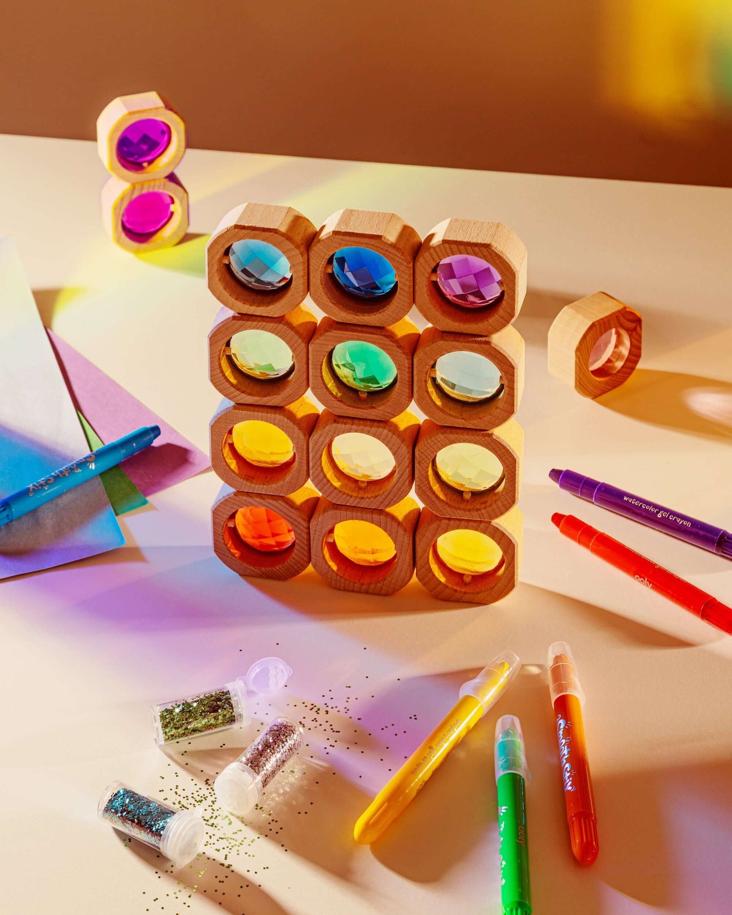 Colorful wooden block puzzle with markers on a light surface
