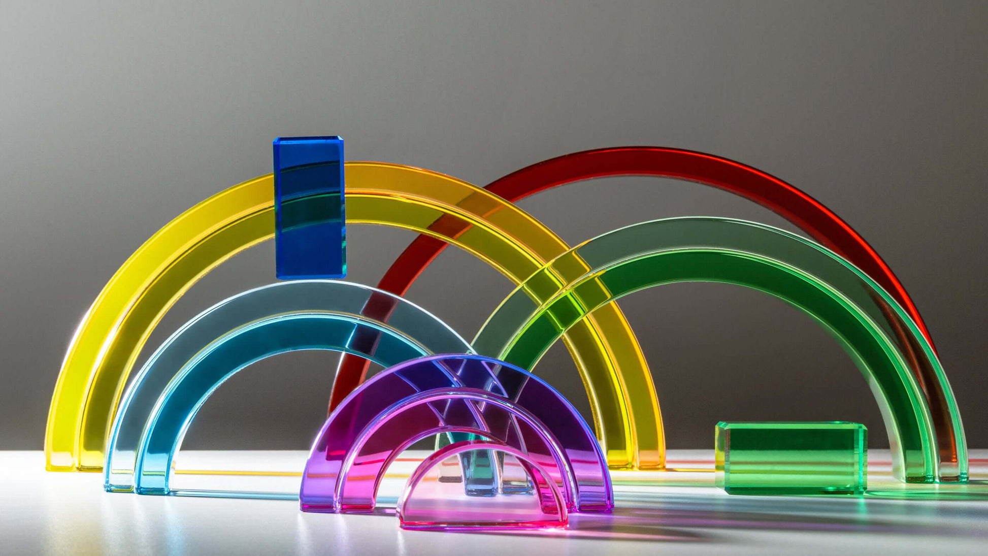 Lucid Rainbow acrylic stacking toy with colorful translucent arches for imaginative play.