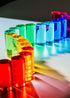 Rainbow lucite blocks lined up to create a rainbow reflection