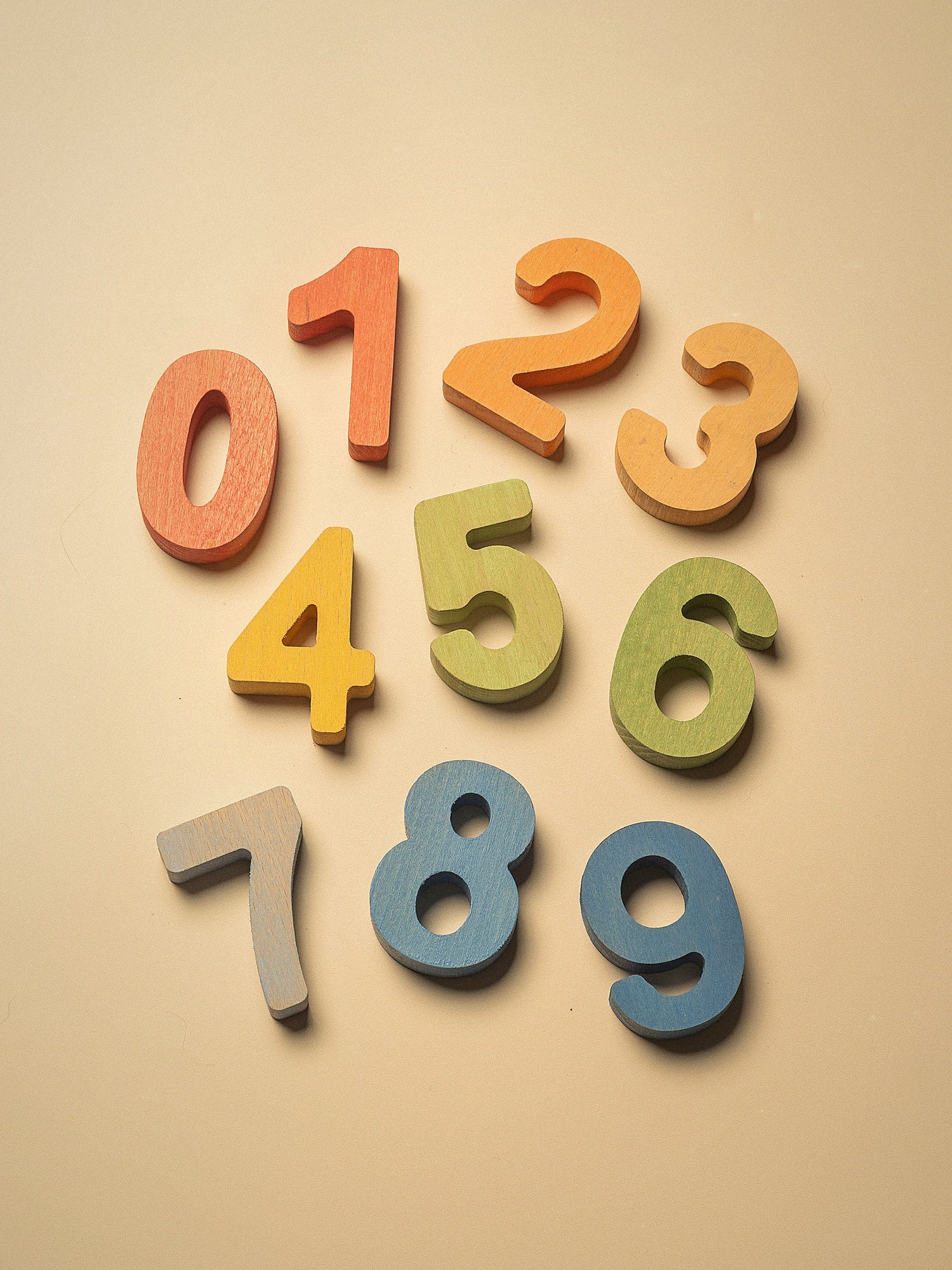 Colorful wooden numbers for early math, featuring digits 0-9. Perfect for learning with a Wooden numbers puzzle for early math.