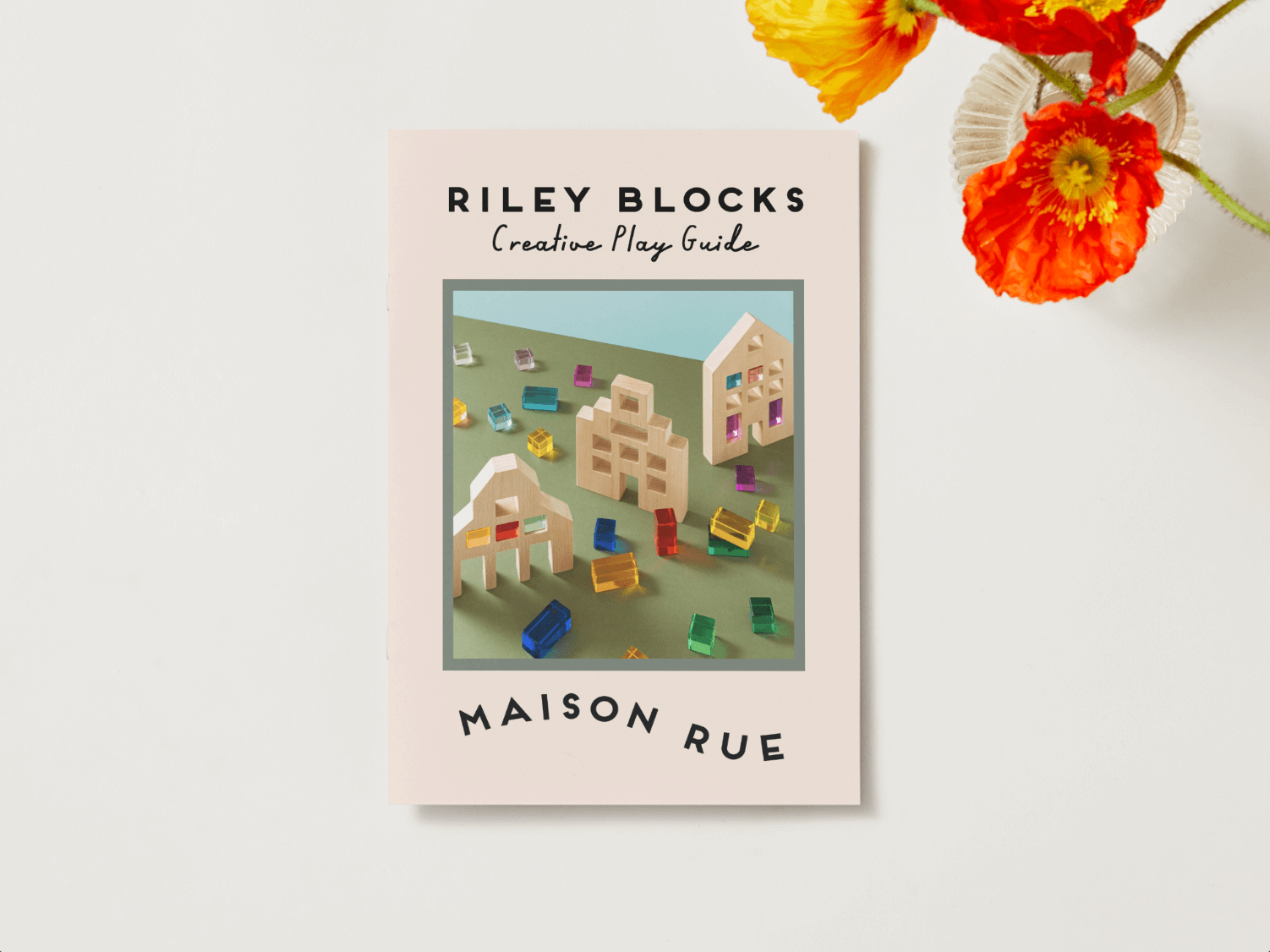 Alt Tag: Riley Blocks Digital Play Guide cover with creative play activities using colorful blocks and wooden houses on a tabletop