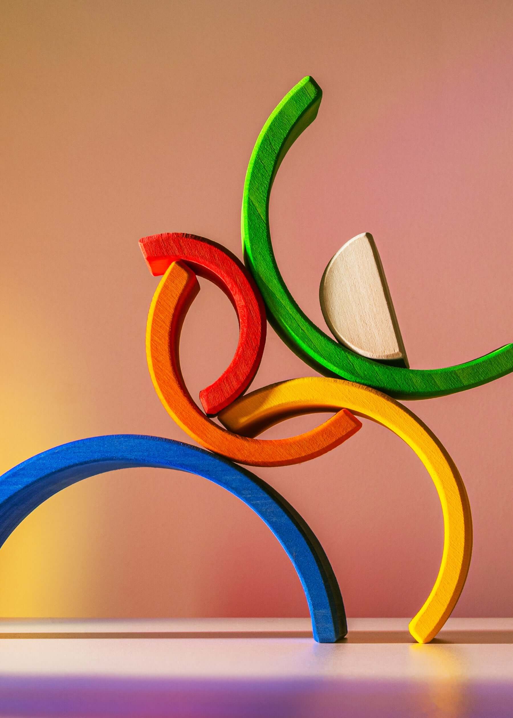 Colorful Small Wooden Rainbow stacking toy with vibrant arches for imaginative play.