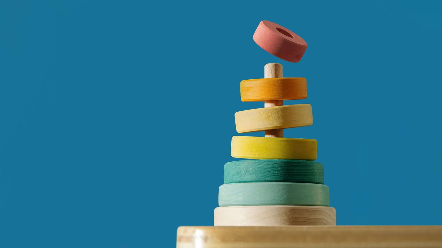 Suki Stacking Tower wooden ring stacking toy with pastel colors for toddlers, builds fine motor skills and coordination