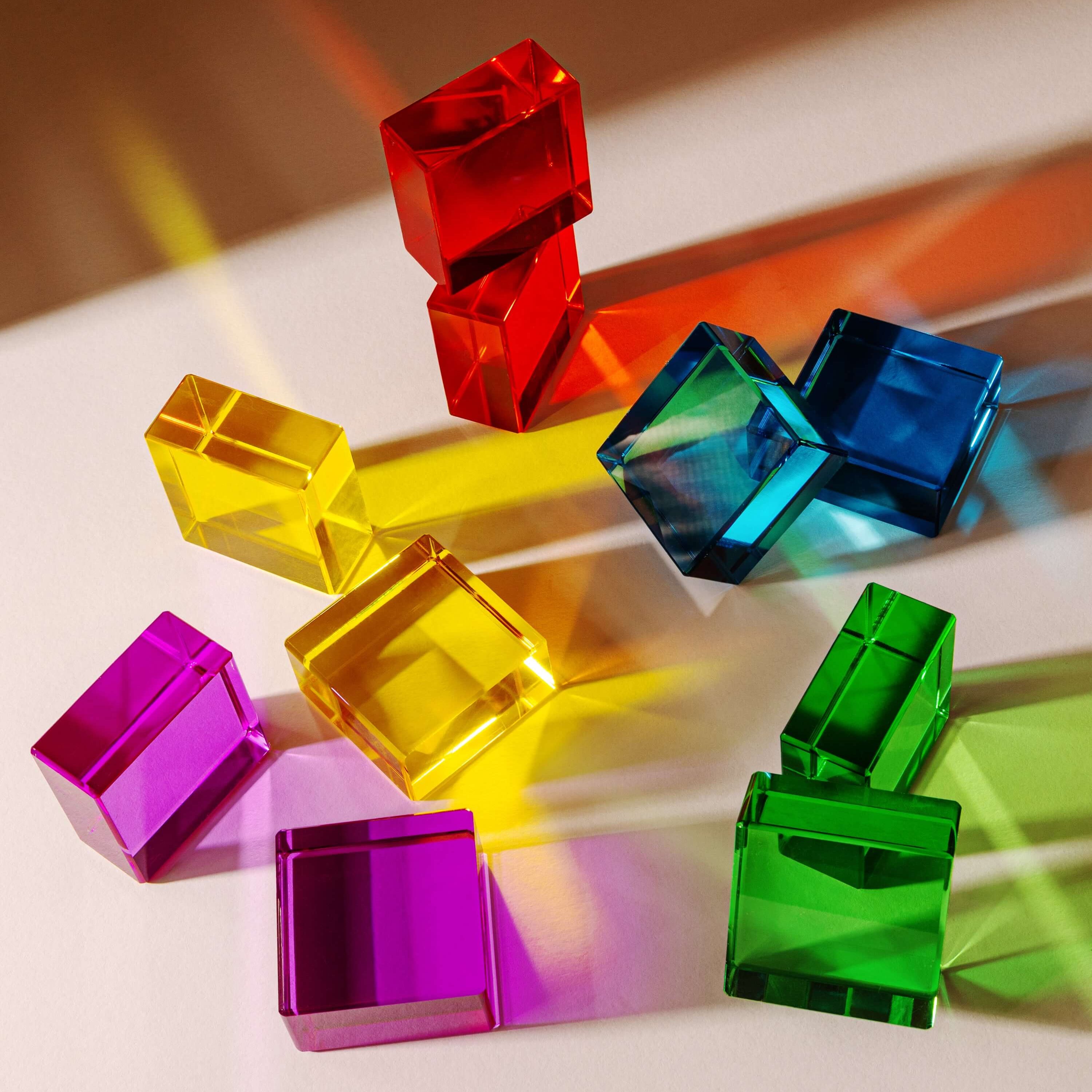 Colorful Theo Blocks in various shapes, showcasing vibrant transparency and ideal for creative play.
