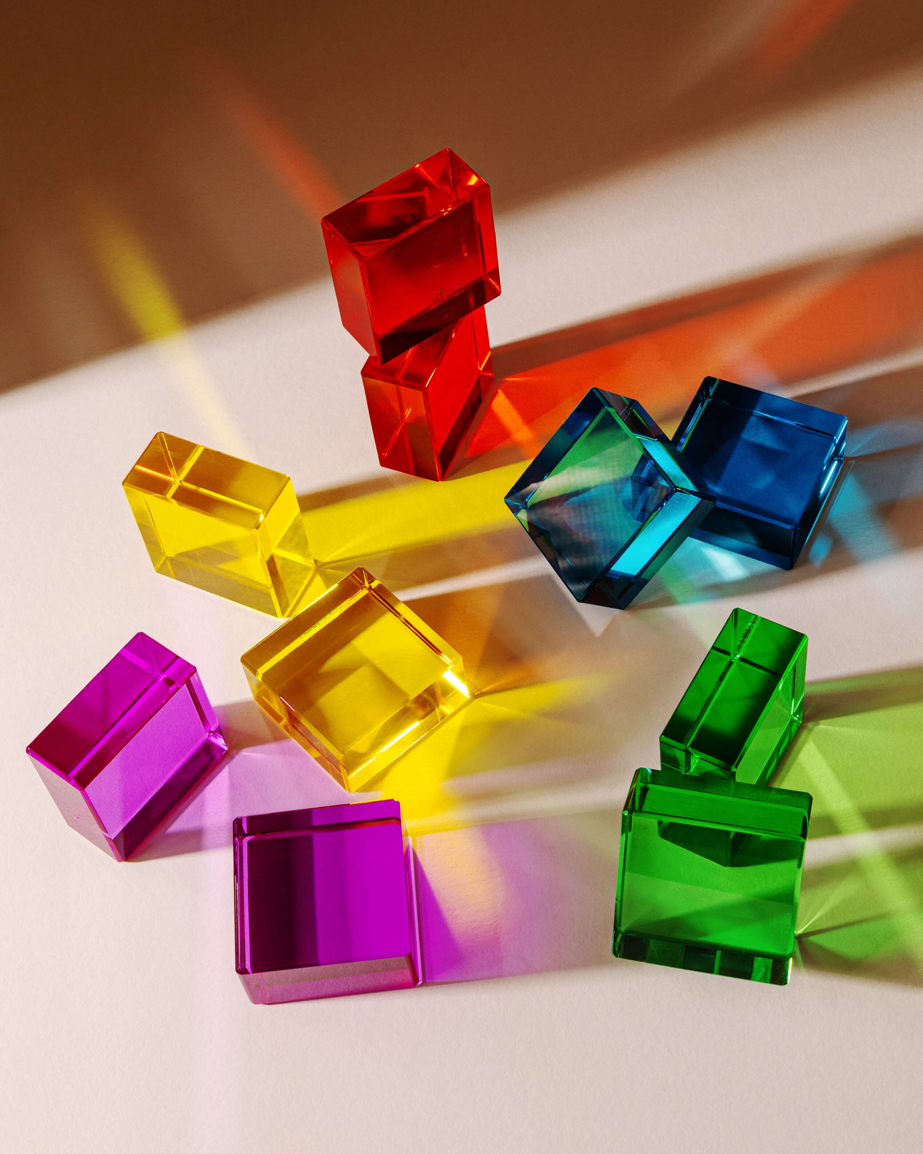 Colorful Theo Blocks in various shapes, showcasing vibrant transparency and ideal for creative play.