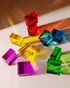 Colorful Theo Blocks in various shapes, showcasing vibrant transparency and ideal for creative play.