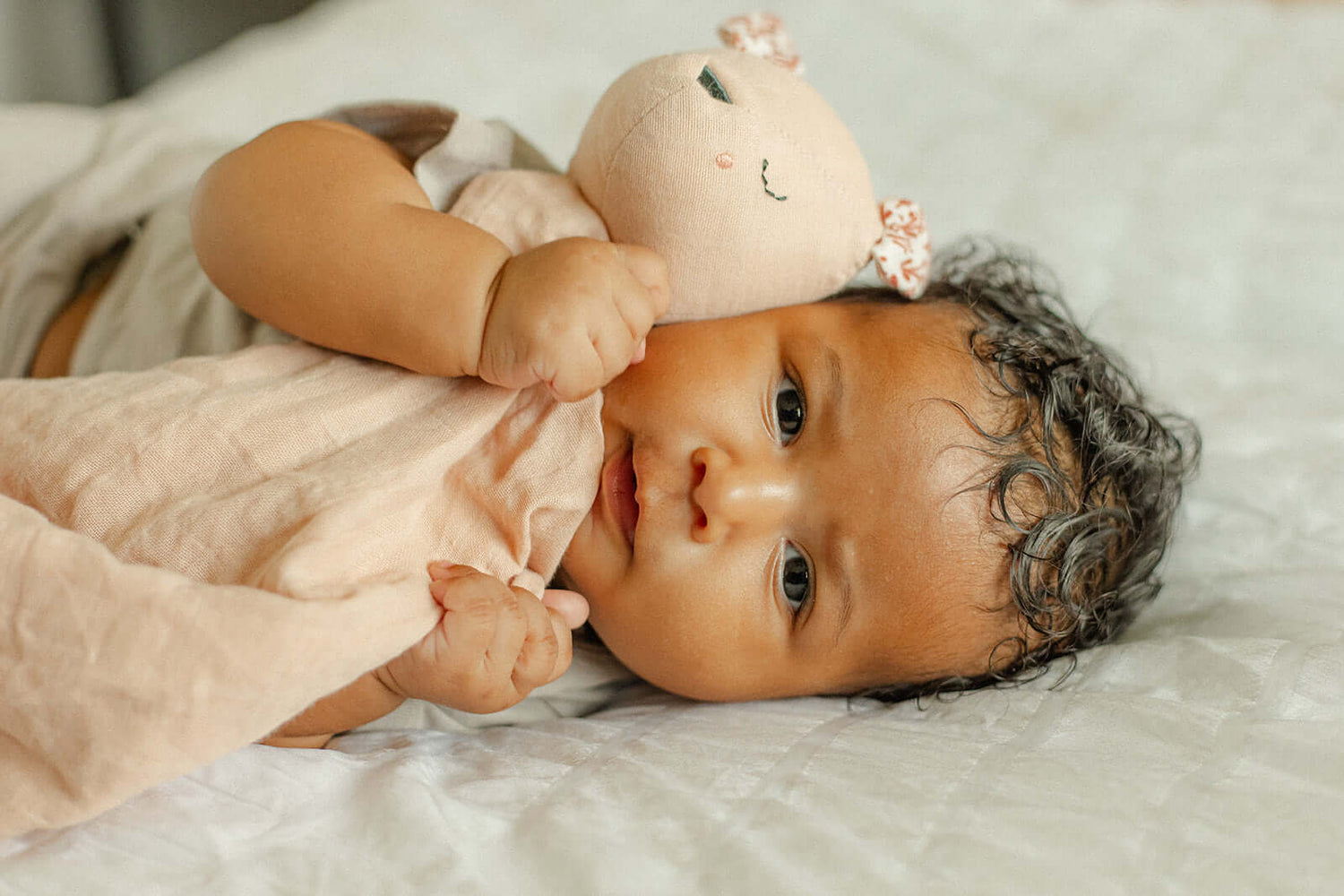 Pocket Pals organic cotton squirrel lovey comforter with fern print pocket, baby cuddling soft comfort blanket on bed