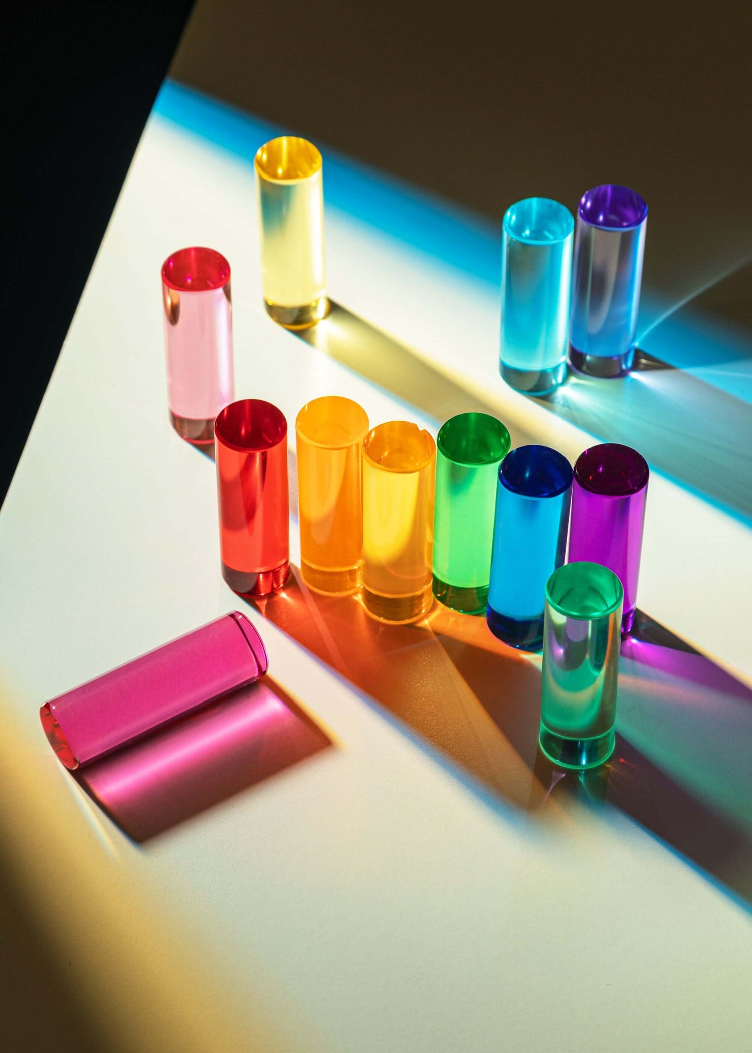 Colorful round blocks arranged on a reflective surface with a gradient light effect.